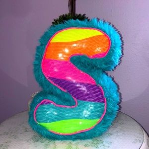 Justice S-shaped neon throw pillow